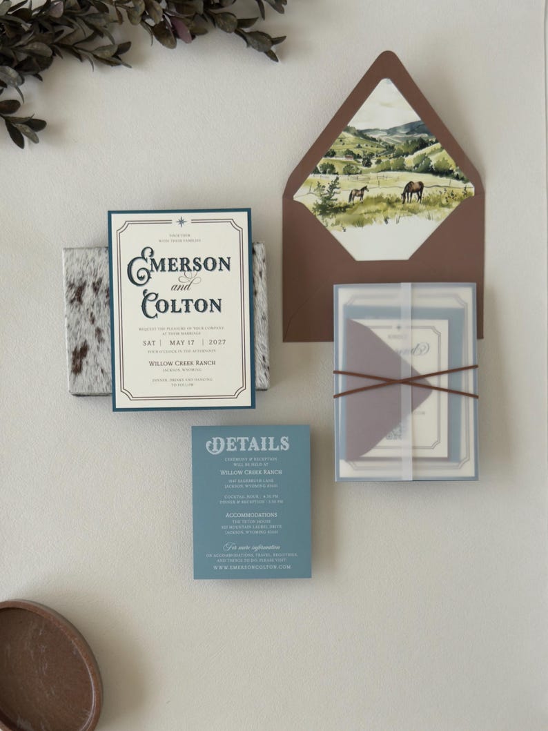 Emerson western wedding invitation suite shown in an assembly video featuring dusty blue, warm brown and ivory stationery with vintage ranch-inspired details.