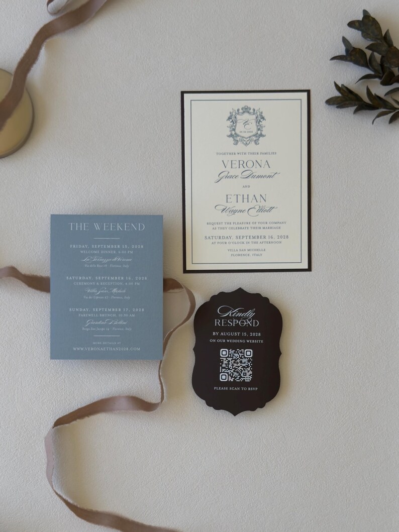 Dusty blue wedding details card with ivory invitation, brown RSVP card