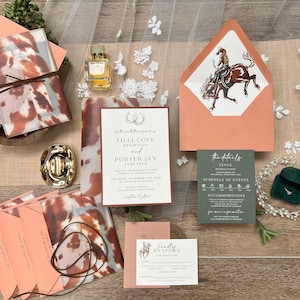 May include: Wedding invitation suite with a rustic theme. Includes invitation cards, RSVP cards, and envelopes in shades of peach, brown, and green. Features a cowboy and horse illustration.