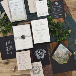 May include: An assortment of wedding stationery, including invitations, RSVP cards, and details cards. The designs feature elegant fonts, floral accents, and a mountain landscape. The color palette includes black, white, and neutral tones.