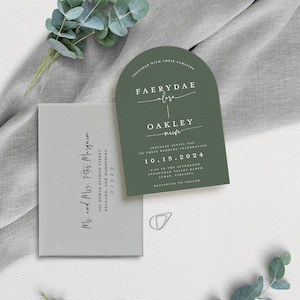 May include: A green wedding invitation with a rounded arch shape. The invitation features the names "Faerydae" and "Oakley" in a script font. The date of the wedding is "10.15.2024" and the location is "Stoneyman Valley Ranch, Luray, Virginia".