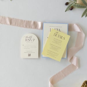 Ivory arch RSVP card and butter yellow wedding details card styled with blush ribbon from the romantic pastel Lucia wedding invitation suite.