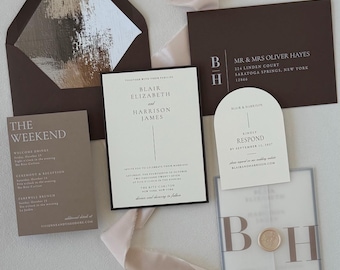May include: A wedding invitation suite featuring a dark brown envelope with a brushstroke liner, a rectangular main card, a weekend itinerary card, a dark brown mailing envelope, an arched RSVP card, and a translucent vellum wrap with a wax seal.