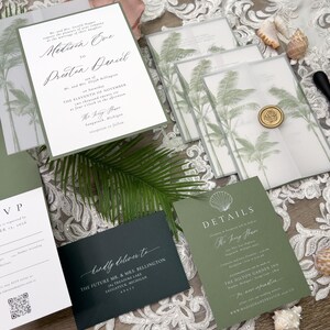 May include: Elegant wedding invitation suite featuring a main invitation, RSVP card, details card, and envelopes. The design includes palm tree illustrations, a wax seal, and calligraphy. The color palette is white, green, and dark green.