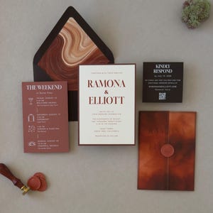 Dark brown wedding envelope with bold abstract liner in rust, terracotta and cream, displayed with the layered Ramona wedding invitation and coordinating RSVP card