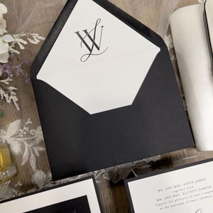 Black and white wedding invitations with classic, timeless design. Minimalist black wedding with white ink floral vellum thick band and monogram wedding logo designed for you.