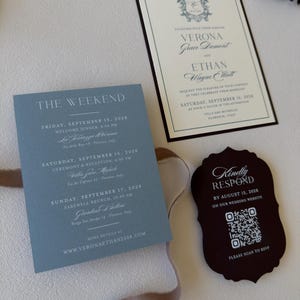 Close-up of dusty blue Verona details card with ivory wedding invitation