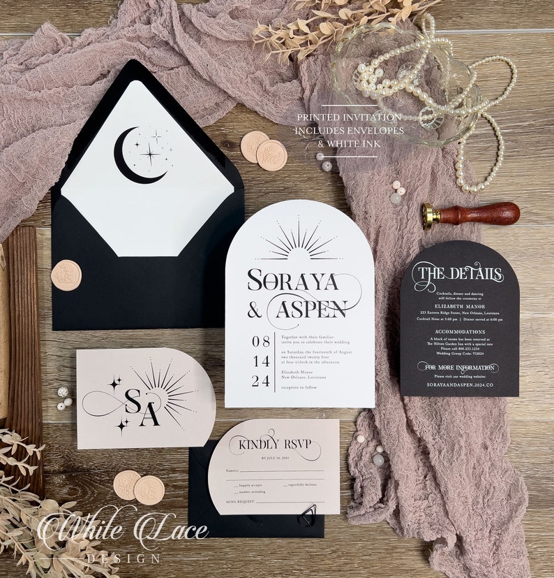May include: Wedding invitation suite with black and blush pink cardstock. The invitation features a modern arch design with a sunburst and the text "Soraya & Aspen" in black script font. The date is printed below in black. The details card features a black background with white text. The RSVP card is black with a blush pink insert. The text "Kindly RSVP" is printed in black script font.