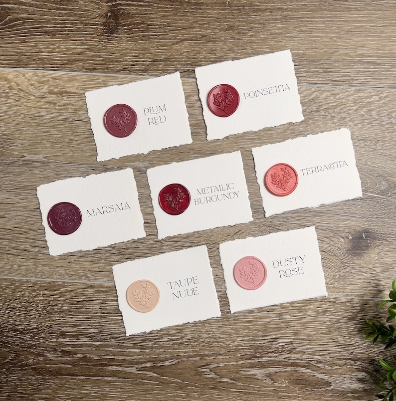 May include: Six rectangular white paper cards with deckled edges, each featuring a circular wax seal with a floral design. The cards are labeled with the text Plum Red, Poinsettia, Marsala, Metallic Burgundy, Terracotta, Taupe Nude, and Dusty Rose.