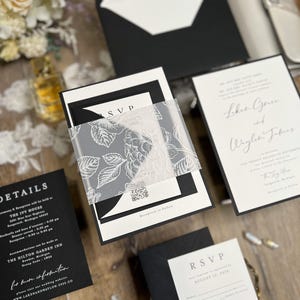 Black and white wedding invitations with classic, timeless design. Minimalist black wedding with white ink floral vellum thick band and monogram wedding logo designed for you.
