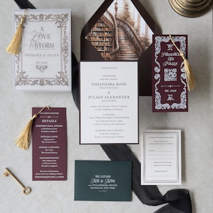 May include: A wedding invitation suite featuring a white card with gold tassel, a dark burgundy envelope with a library staircase illustration, a burgundy card with a QR code and gold tassel, a burgundy details card, a dark green envelope, and a small RSVP card.