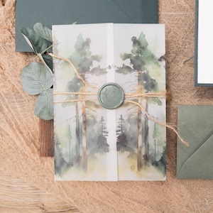 May include: A watercolour illustration of a woodland scene printed on a white paper card with a green wax seal. The card is tied with twine and is sitting on a brown hessian surface.