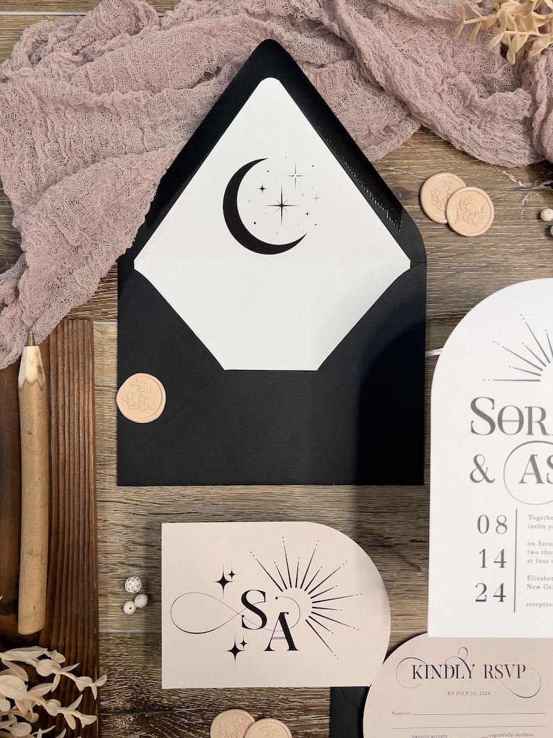 May include: A black and white wedding invitation with a moon and stars design. The invitation is on a pink background with the initials "SA" in a stylized infinity symbol. The text on the invitation reads "SOR & AS" and "KINDLY RSVP BY JULY 16, 2024".