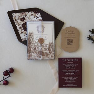European villa wedding invitation with printed vellum wrap and patterned burgundy envelope liner
