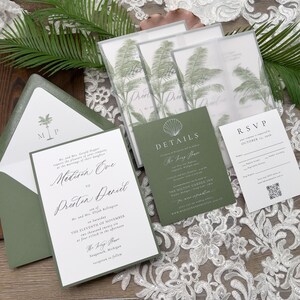 May include: Wedding invitation suite featuring a green and white color scheme. The invitation includes a palm tree graphic and elegant script. The suite includes an RSVP card, details card, and envelope.