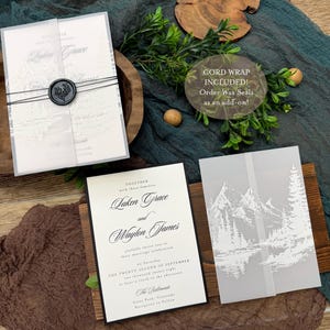 May include: Elegant wedding invitation suite featuring a main invitation with black text, a translucent overlay with a mountain scene, and a wax seal. The suite includes a cord wrap and the text "CORD WRAP INCLUDED! Order Wax Seals as an add-on!"