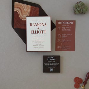 Modern Ramona wedding invitation paired with a rust details card and dark chocolate square RSVP card, styled in warm earthy tones on a neutral background.