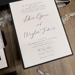 Black and white wedding invitations with classic, timeless design. Minimalist black wedding with white ink floral vellum thick band and monogram wedding logo designed for you.