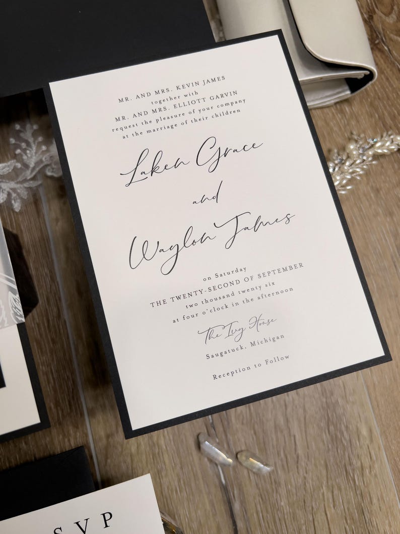 Black and white wedding invitations with classic, timeless design. Minimalist black wedding with white ink floral vellum thick band and monogram wedding logo designed for you.