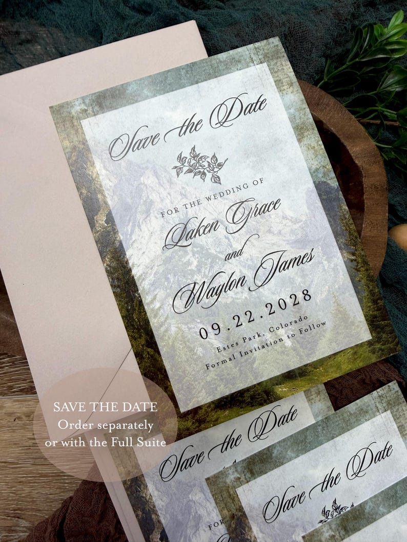 May include: Wedding "Save the Date" cards with a mountain landscape design. The cards feature elegant calligraphy with the names "Laken Grace and Waylon James" and the date "09.22.2028". The text "Save the Date" is also visible.