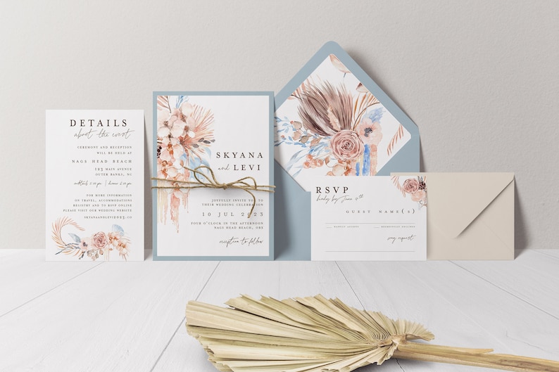 May include: Wedding invitation suite with a dusty blue envelope featuring a watercolor floral design with dried grasses and a peach rose. The invitation card is white with a floral design and the text "Skyana and Levi" and "10 Jul 2023". The RSVP card is white with the text "RSVP" and "Guest Name(s)".