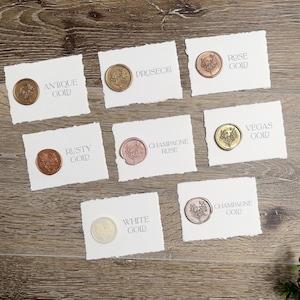 May include: Seven rectangular white cards with deckled edges, each featuring a circular wax seal with a floral design. The cards are labeled with the text: Antique Gold, Prosecco, Rose Gold, Rusty Gold, Champagne Rose, Vegas Gold, White Gold, and Champagne Gold.