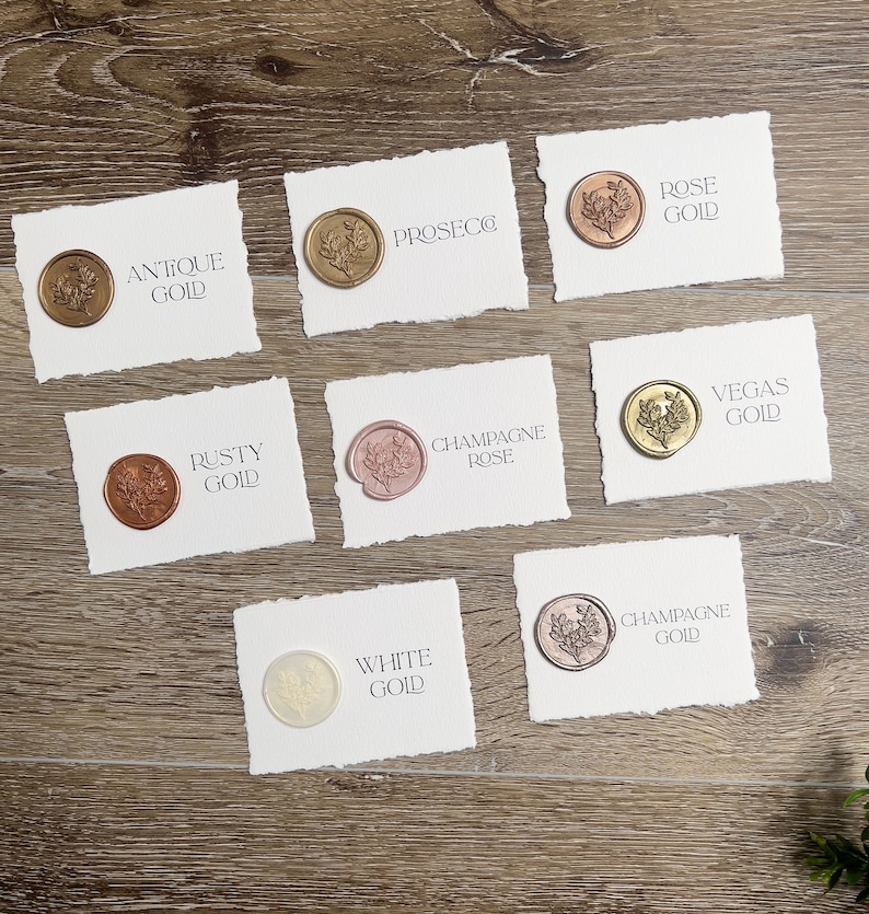 May include: Seven rectangular white cards with deckled edges, each featuring a circular wax seal with a floral design. The cards are labeled with the text: Antique Gold, Prosecco, Rose Gold, Rusty Gold, Champagne Rose, Vegas Gold, White Gold, and Champagne Gold.