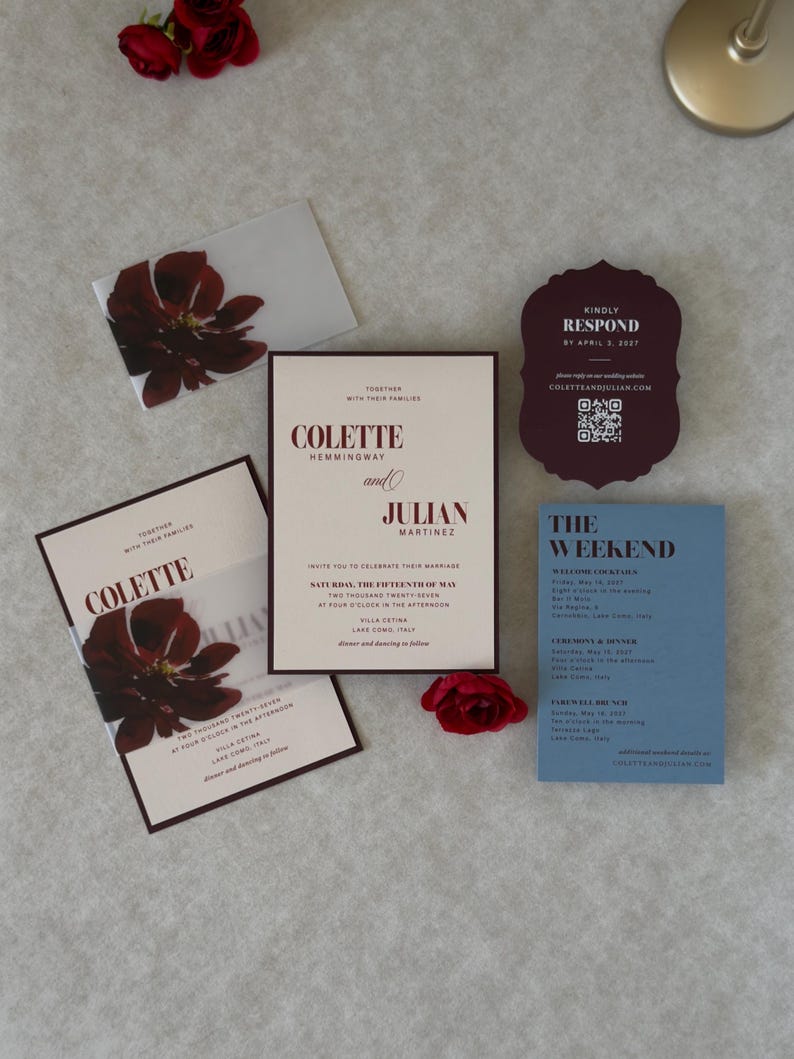 Coordinating wedding invitation cards in dusty blue, burgundy and ivory, showing the details card, scalloped RSVP and floral invitation from a romantic burgundy and blue wedding stationery suite.
