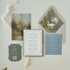 Romantic Yvette invitation suite featuring an ivory bordered wedding invitation, dusty blue details card, green scalloped RSVP and envelope with graceful swan liner.