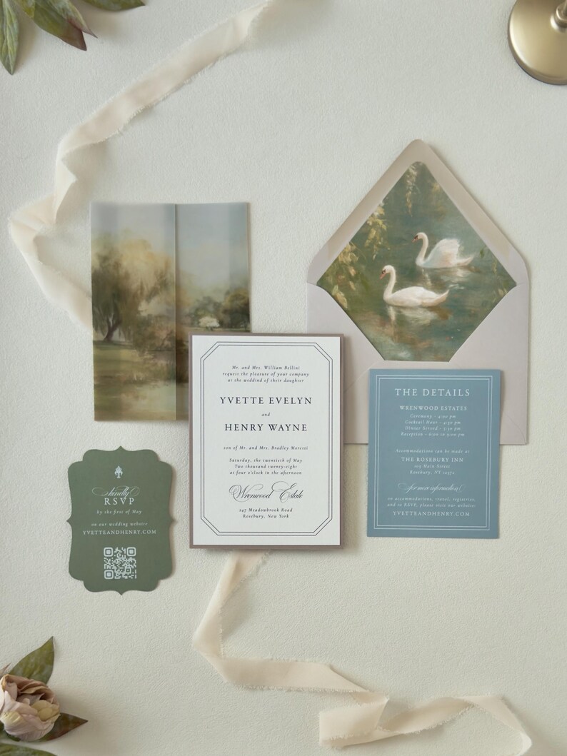 Romantic Yvette invitation suite featuring an ivory bordered wedding invitation, dusty blue details card, green scalloped RSVP and envelope with graceful swan liner.