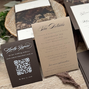 May include: A set of wedding stationery including a dark brown RSVP card with a white QR code and the text Kindly Respond, and a tan details card with black text reading The Details, Lighthouse Inn, and event times for a wedding ceremony.