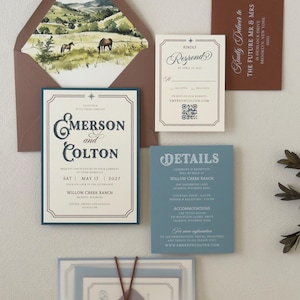 Warm brown envelope with scenic ranch landscape liner displayed with the ivory Emerson invitation, dusty blue details card and square RSVP card.
