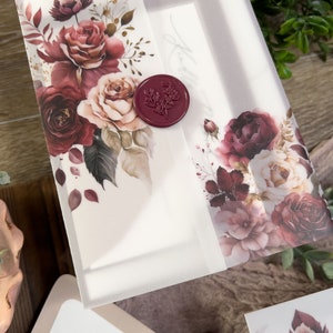 Romantic burgundy floral wedding invitation with vellum wrap, wax seal and dusty rose botanical artwork.