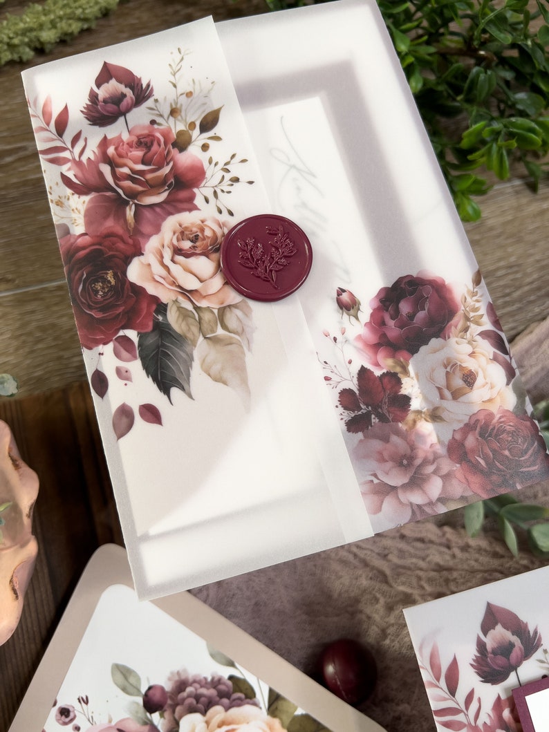 Romantic burgundy floral wedding invitation with vellum wrap, wax seal and dusty rose botanical artwork.