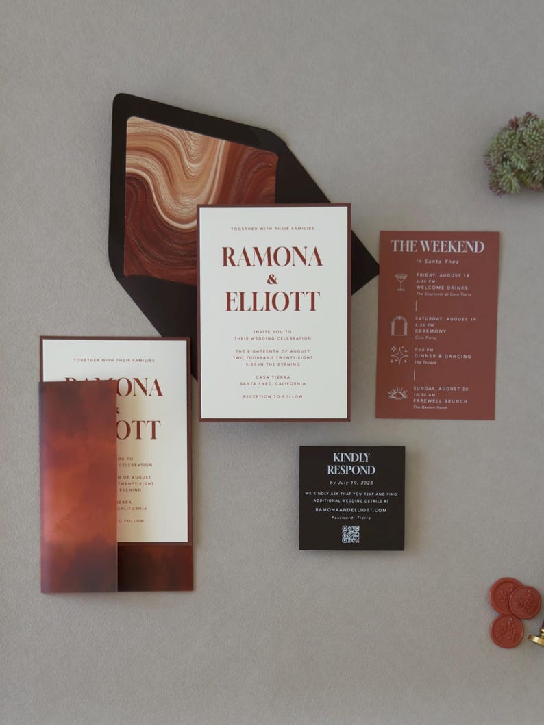 Modern rust and chocolate wedding invitation featuring a warm ivory invitation layered over a dark brown backing mat with a bold abstract envelope liner in earthy terracotta tones.