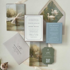 Romantic countryside Yvette wedding invitation suite featuring an ivory bordered invitation, dusty blue details card, dark green scalloped RSVP card and soft landscape vellum wrap with coordinating swan envelope liner.
