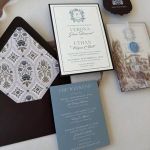 Verona wedding invitation with dusty blue details card, brown envelope and European villa vellum wrap