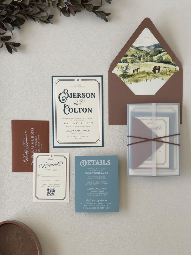 Warm brown, dusty blue and ivory Emerson wedding invitation suite with square RSVP card, translucent stationery layers and scenic landscape envelope liner.