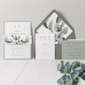 May include: Wedding invitation suite with a green and white color scheme. The invitation features a watercolor illustration of eucalyptus leaves and the text "J & L, together with their families, Journi Mae, Saturday, June Fourteenth, The Frinterse". The RSVP card has the text "RSVP by May 1st, 2024, Name(s)". The details card has the text "The Details, Ceremony & Reception will be held at The Farmers, 6222 Old Mill Rd, Montgomery, Texas, To confirm our Wedding Registry, Travel Information, and as RSVP Guest please visit our wedding website".