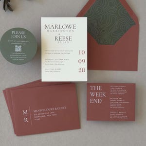 Modern terracotta and olive wedding invitation suite with ivory asymmetrical invitation, round green RSVP card, clay details cards and coordinating patterned envelope liner.