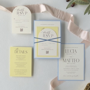 Romantic blue and yellow wedding invitation suite featuring a layered invitation, ivory arch RSVP card and watercolor floral details for a garden wedding.