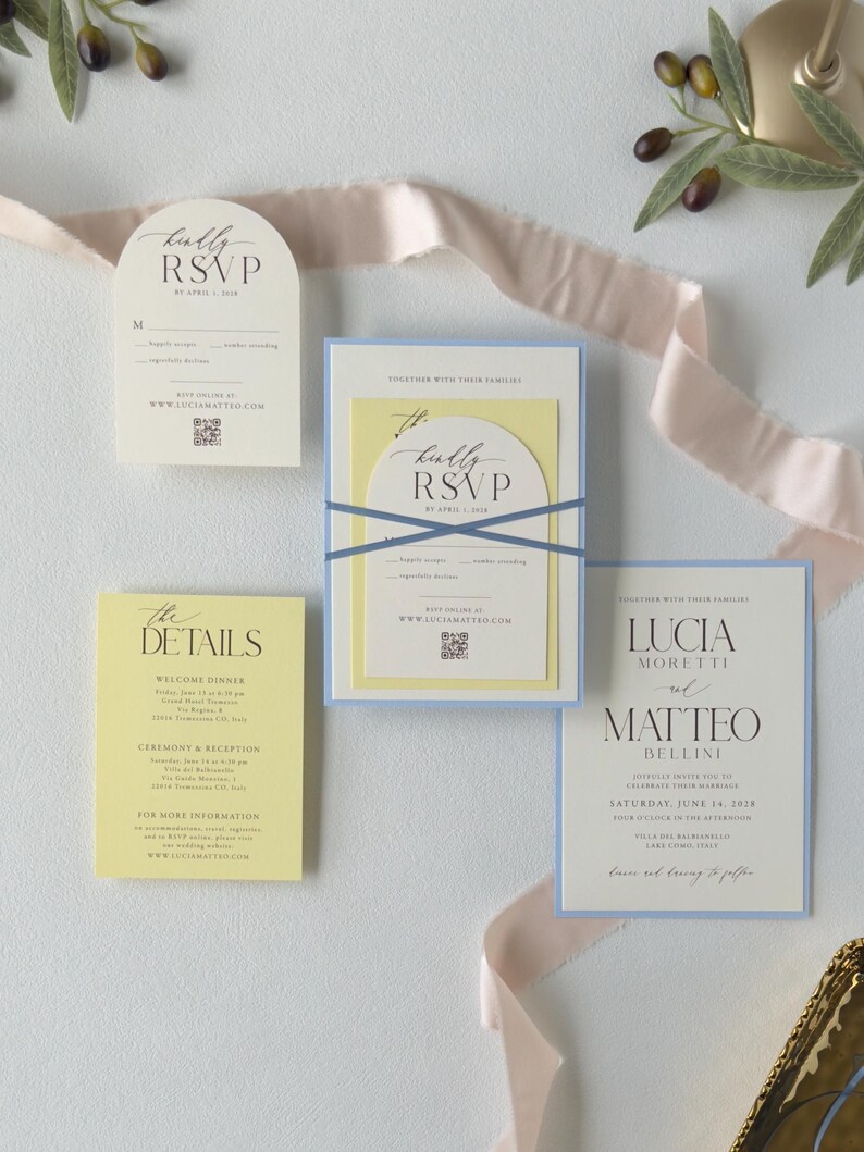 Romantic blue and yellow wedding invitation suite featuring a layered invitation, ivory arch RSVP card and watercolor floral details for a garden wedding.