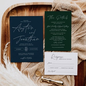 May include: A navy blue and green wedding invitation suite with white calligraphy. The invitation card features the names Austen and Jonathan, the date November 22, 2024, and the location Black Forest by Wedgewood, Colorado Springs, Colorado. The details card includes the ceremony and reception location, date, time, and website address. The response card has a space for the guest's name, RSVP options, and a space for a song request.