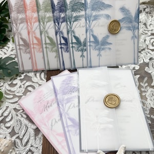 May include: A collection of wedding invitations with a tropical palm tree design. The invitations feature a translucent overlay with a gold wax seal. The color palette includes shades of pink, purple, blue, and green.