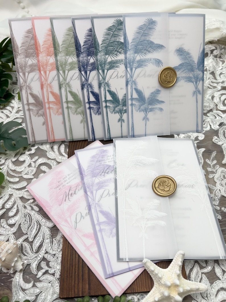 May include: A collection of wedding invitations with a tropical palm tree design. The invitations feature a translucent overlay with a gold wax seal. The color palette includes shades of pink, purple, blue, and green.