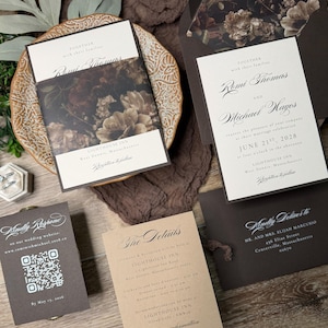 May include: A wedding invitation suite featuring cream-colored cards with dark brown text and floral envelope liners. The set includes a main invitation, a details card, an RSVP card with a QR code, and a dark brown envelope with floral interior.