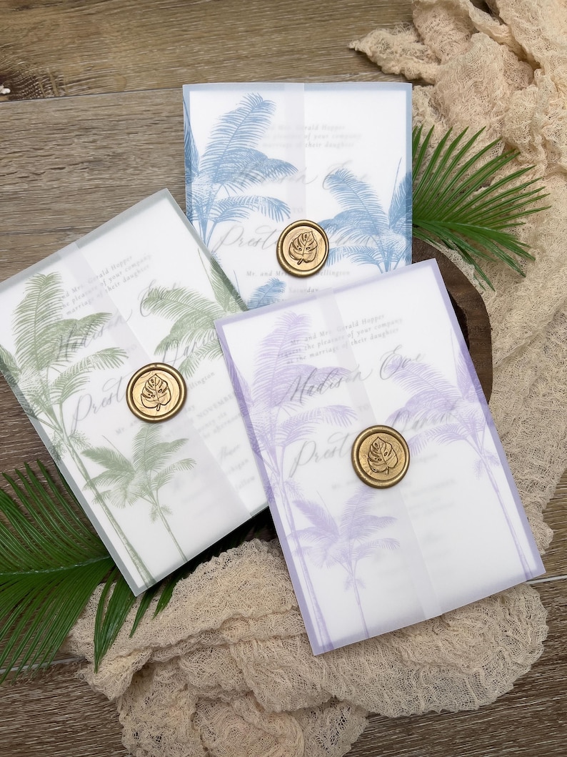May include: Three wedding invitation suites in blue, green, and purple, each featuring a palm tree design. The invitations are sealed with a gold wax stamp. The text "Pratt" is visible on each invitation.
