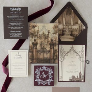 Aurelia dark romantic wedding invitation suite arranged with castle-gate vellum artwork, Wedding Cream invitation, Bitter Chocolate details card, traditional RSVP card, Claret crest tag, and dark brown envelope with Gothic cathedral-inspired liner.