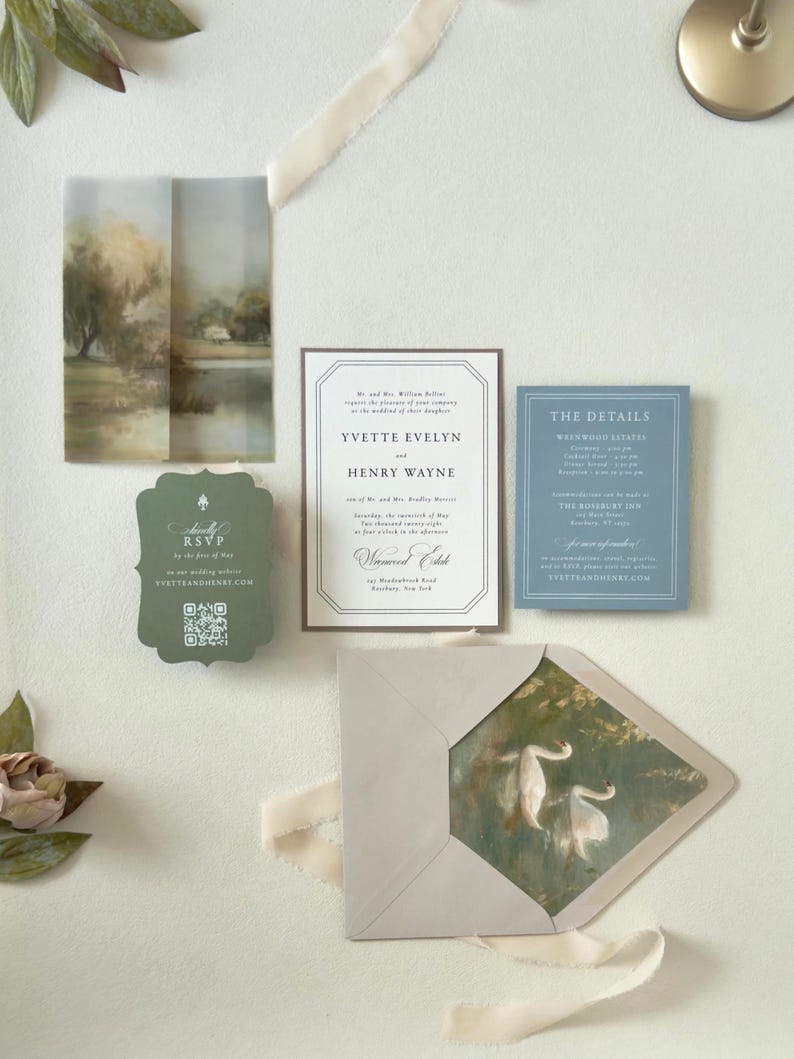 Ivory, dusty blue and dark green wedding invitation suite featuring vintage-inspired typography, scalloped RSVP card, scenic vellum artwork and elegant countryside details.
