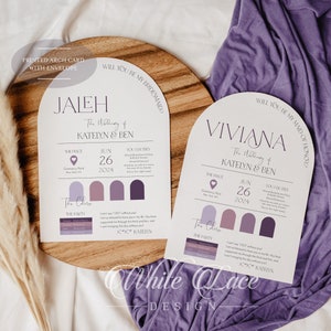 May include: Two white arch-shaped cards with purple text and accents. The text on the cards reads "Will you be my bridesmaid?" and "Will you be my maid of honor?" The cards are on a wooden surface with a purple fabric in the background.